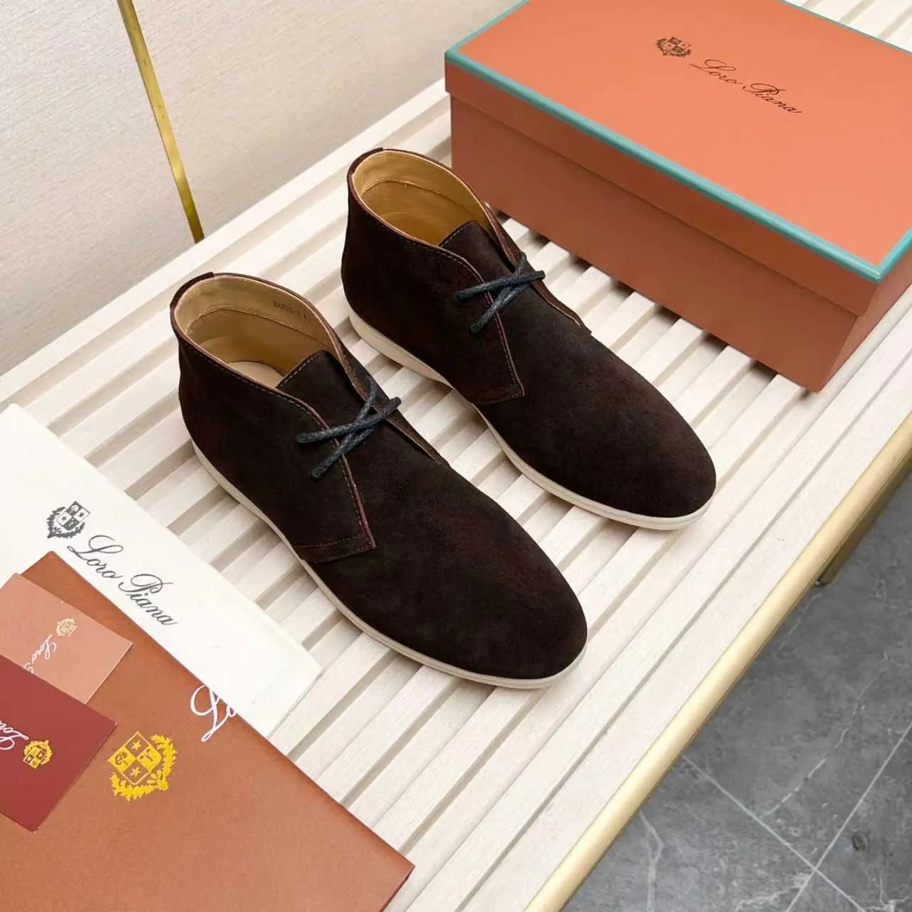 Men's Shoes 💰420 Loro Piana reimagines the desert boot—a modern, comfortable interpretation of a classic 1940s style. Crafted from suede calfskin, it exudes elegance. The tight texture of suede calfskin is not only durable but also looks casual and sophisticated. Add a timeless piece to your shoe collection, harmoniously blending comfort, style and Loro Piana's heritage of craftsmanship. Acetate satin detail on the inside White sole with LP lettering for added traction Space for a personalized signature on the heel Tonal suede trim Upper: 100% cow split suede Sole: 100% Rubber lining: Cow leather